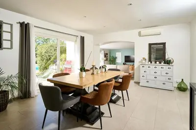 a dining room with a wooden table and chairs at Maison au calme proche Mont Ventoux et Luberon in Malemort-du-Comtat