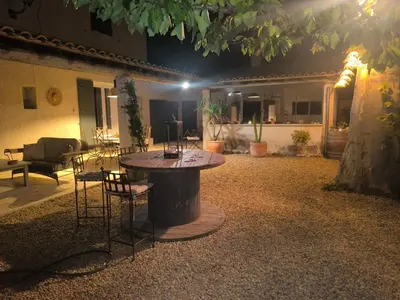 a patio with a table and chairs in front of a house at Gîte en Provence in Cavaillon