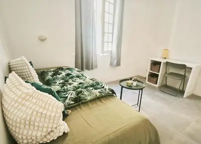 a living room with a couch and a table at Studio neuf avec clim au centre d'Aix 1er étage in Aix-en-Provence