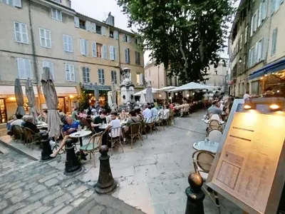 a group of people sitting at tables on a street at Studio plein centre Aix-en-Provence in Aix-en-Provence