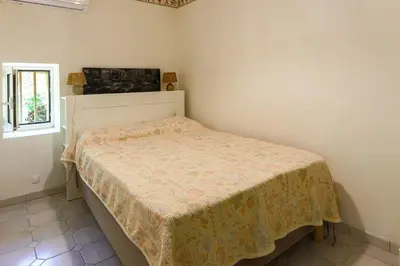 a small bedroom with a bed in a room at Le Gran Cabano sous les oliviers in Saint-Rémy-de-Provence