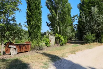 an old train sitting on the side of a dirt road at Le Gran Cabano sous les oliviers in Saint-Rémy-de-Provence
