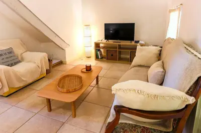 a living room with a couch and a coffee table at Le Gran Cabano sous les oliviers in Saint-Rémy-de-Provence