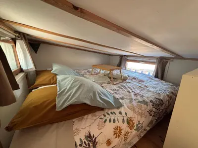 a bed in the middle of a room at La Tiny du Luberon in Pertuis