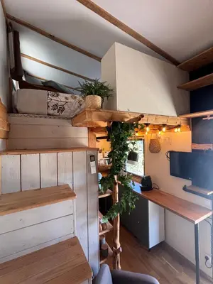 a tiny house with a kitchen and a desk at La Tiny du Luberon in Pertuis