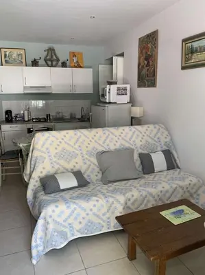 a living room with a couch and a kitchen at Le Yodala - Lamanon in Lamanon