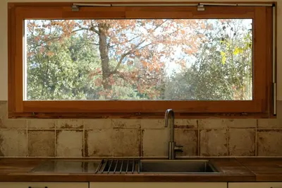 a kitchen sink with a window above it at La Source in Saint-Saturnin-les-Apt
