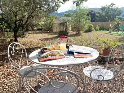 a table with two chairs with candles on it at La maison aux oiseaux - Luberon in Oppède