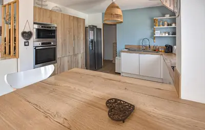 a wooden table in a kitchen with a spoon on it at Maison Avec Piscine Privée in Monteux
