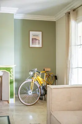 a yellow bike parked in a room with a wall at Villa Sun7 in Crillon-le-Brave