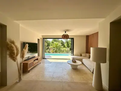 a living room with a couch and a bed and a table at Casa Bohemia, piscine privée proche Aix en Provence in Ventabren