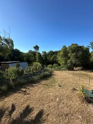 a garden with a fence and trees in the background at Casa Bohemia, piscine privée proche Aix en Provence in Ventabren