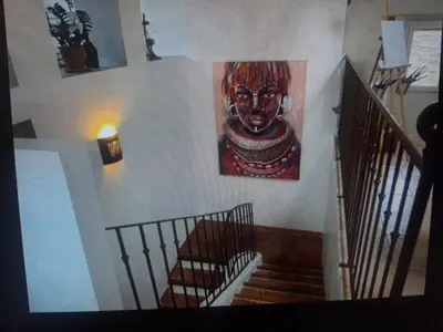 a staircase with a painting on the wall at Superbe appartement au pied du Mont Ventoux in Caromb
