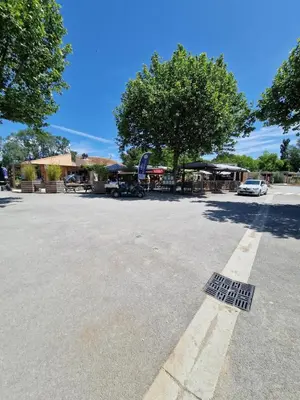 a parking lot with a drain in the street at Mobil home en Provence - Camping 4 étoiles- 2 chambres -4 à 6 pers-clim-terrasse-TV in Cadenet