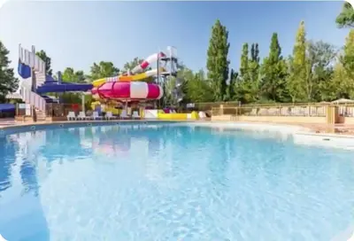 a large swimming pool with a water slide at Mobil home en Provence - Camping 4 étoiles- 2 chambres -4 à 6 pers-clim-terrasse-TV in Cadenet