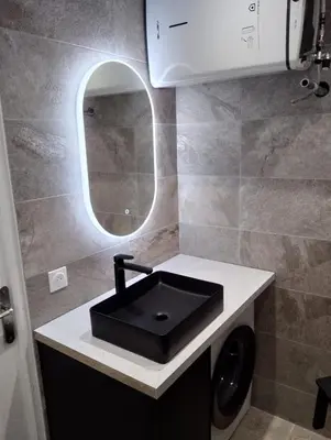 a bathroom with a sink and a mirror at Aix Centre-ville in Aix-en-Provence