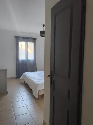 an open door to a bedroom with a bed at Appartement idéal séjour touristique et pro in Vedène