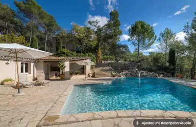 a swimming pool in the backyard of a house at Maison et studio avec vue panoramique et piscine in La Bastidonne