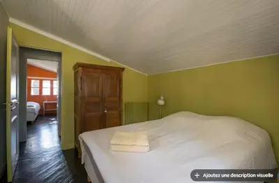 a large kitchen with a wooden table and chairs at Maison et studio avec vue panoramique et piscine in La Bastidonne