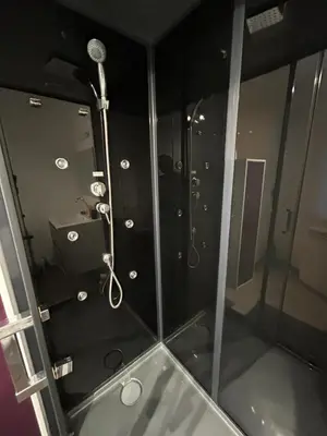 a shower with a glass door in a bathroom at T2 centre-ville avec parking privé inclus in Cavaillon