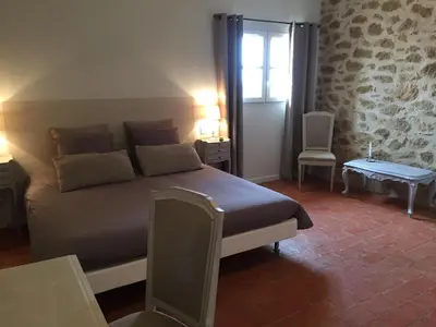 a bedroom with a bed in a room with a window at La Rivayne in Lourmarin