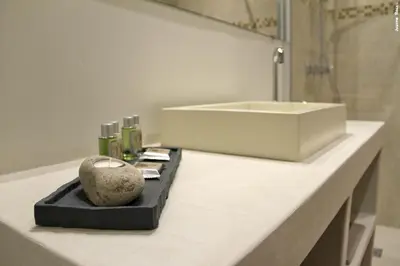 a bathroom counter with a sink and a rock on it at La Rivayne in Lourmarin