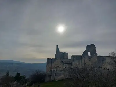 an old castle on a hill with the moon in the sky at La Clemensane in Lacoste