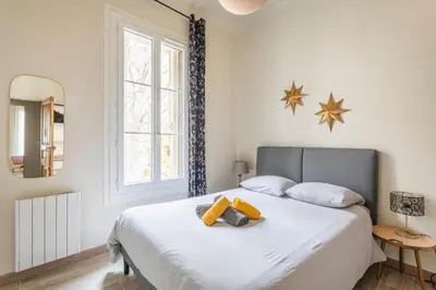 a bedroom with a large white bed with a mirror at Beautiful 3 bedrooms in a detached house in Aix-en-Provence