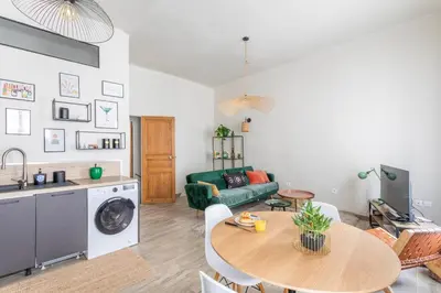 a living room with a table and a green couch at Beautiful 3 bedrooms in a detached house in Aix-en-Provence