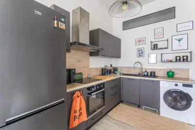 a kitchen with a refrigerator and a washing machine at Beautiful 3 bedrooms in a detached house in Aix-en-Provence