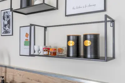 a shelf on a wall with two black containers at Beautiful 3 bedrooms in a detached house in Aix-en-Provence