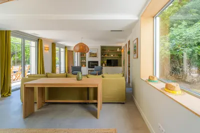 a living room with a table and a yellow couch at L'Echappée aixoise in Aix-en-Provence