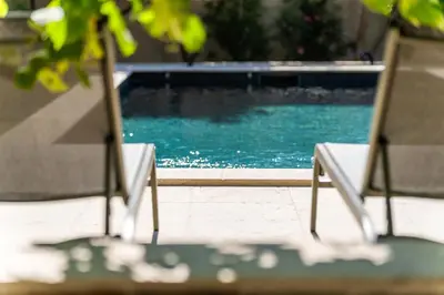 two chairs sitting next to a swimming pool at L'Echappée aixoise in Aix-en-Provence