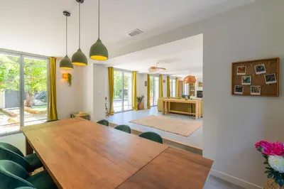 a dining room with a wooden table and chairs at L'Echappée aixoise in Aix-en-Provence