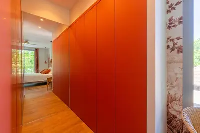 a hallway with orange paneled walls in a bedroom at L'Echappée aixoise in Aix-en-Provence
