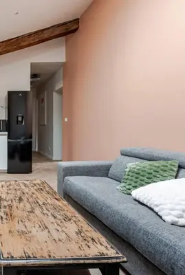 a living room with a couch and a table at Le fort 7 Appart centre ville in LʼIsle-sur-la-Sorgue