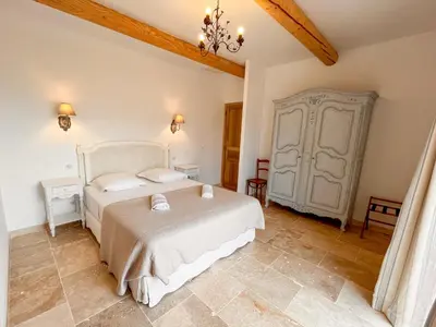 a bedroom with a bed in a room at Maison de charme 4 étoiles - superbe vue et bassin-piscine privé in Rustrel