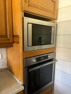 a microwave sitting on top of a oven at Charming ground floor house with pool in Peyrolles-en-Provence