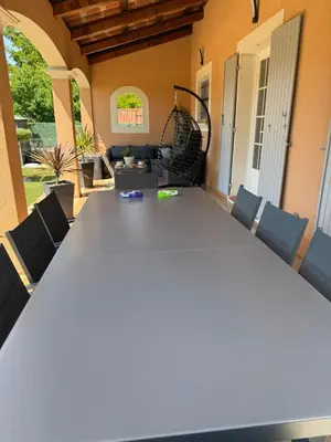 a large long table in a room with chairs at Charming ground floor house with pool in Peyrolles-en-Provence