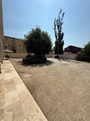 a car parked in a parking lot next to a building at Appart hotel bonpas in Noves