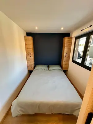 a small bedroom with a bed and a window at Maison avec jaccuzzi Aix-en-Provence in Aix-en-Provence