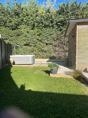 a backyard with a hot tub in the grass at Maison avec jaccuzzi Aix-en-Provence in Aix-en-Provence