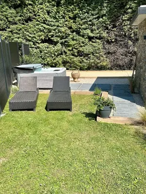 two chairs and a table in a yard at Maison avec jaccuzzi Aix-en-Provence in Aix-en-Provence