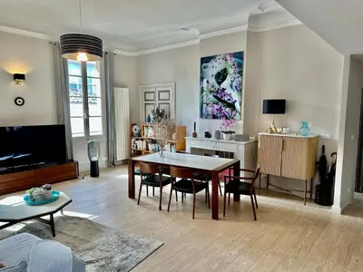 a living room with a table and chairs in it at Aix flat in historic center, 17th century building in Aix-en-Provence