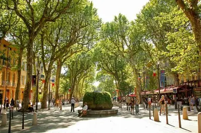 a street with a fountain in the middle of a city at Domaine Saint Roch in Saint-Paul-lez-Durance