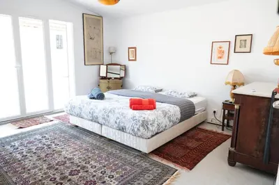 a bedroom with a bed with red pillows on it at Maison Familiale Piscine et Proche des commerces in Pertuis