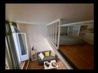 a room with a bunk bed and a couch and a chair at Cosy studio aix en Provence à 1 minutes du cours Mirabeau in Aix-en-Provence