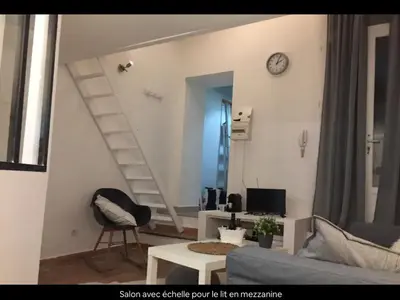 a living room with a staircase in the wall at Cosy studio aix en Provence à 1 minutes du cours Mirabeau in Aix-en-Provence