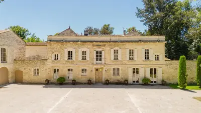 an old stone house with a large driveway at Château Saint Perret in Avignon