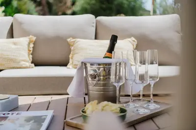 a table with glasses and a bottle of wine on it at Château Saint Perret in Avignon